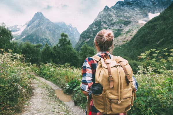 Hiker walking to mountains