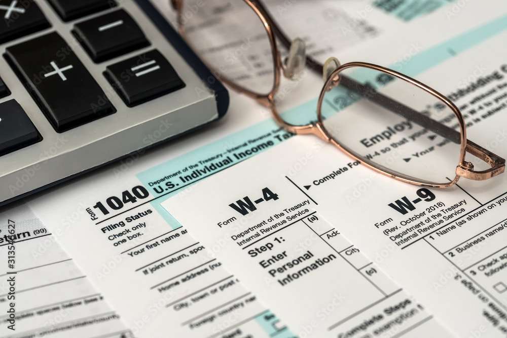 Paper blanks of 1040, w4 and w9 tax form close up